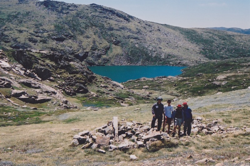 walking group standing among blue lake shelter ruins photo olaf moon 1986