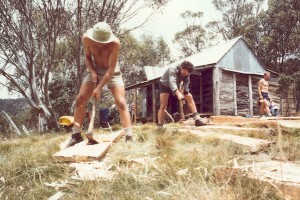 The slab adzing team hard at work. L->R Ian Thompson, Mike Patterson, Pieter Ariens ?. Photo G Handley 1980?